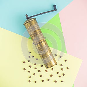 Flat lay of retro coffee grinder on multicolored background