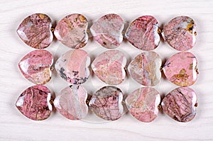 Flat lay rhodonite heart-shaped stones as background