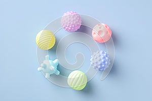 Flat lay rubber kid toys balls for bath on blue background. Minimal style