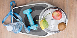 Flat lay scale weighs person with water bottle fruit dumbbells and a meter symbol of good hygiene of life to lose weight in top vi