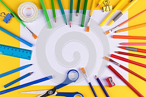 School office supplies on yellow background