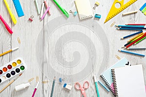 Flat lay school supplies on wooden desk table. Frame made of school stationery, copy space, top view. Back to school concept