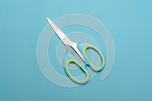 Flat lay of scissors isolated on blue background