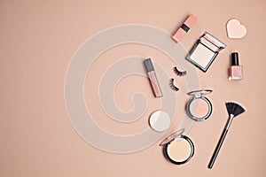 Flat lay with set of professional decorative cosmetics, makeup tools and woman spring, summer accessories over pink background