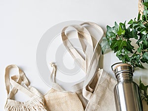 Flat lay set for shopping. Zero waste concept. Reusable fabric and metal bottle for liquids. Top view. copy space photo