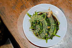 Cah Kangkung or water spinach in the white plate photo