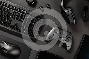 Various modern black wireless devices on desk