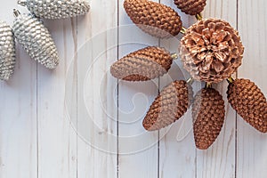 Flat lay with silver and golden Christmas pine cones ornaments o