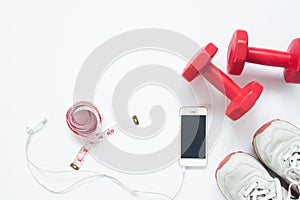 Flat lay of smartphone with measuring tape, red dumbbells