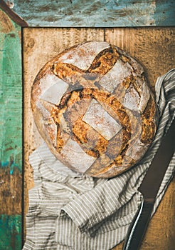 Flat-lay of sourdough wheat bread over rustic background