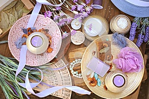 Flat lay spa accessories, handmade artisan soap, fresh flowers, wisp of bast, candles, bath salt