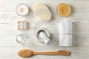 Flat lay with spa accessories on white wooden background