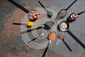 Flat lay of spoons with superfoods, legumes and grains