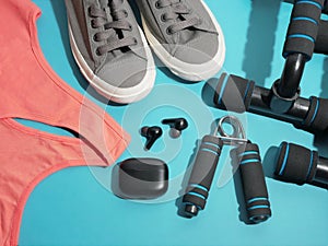 Flat lay of sport and fitness equipment on blue background. pantone stay home training and workout concept