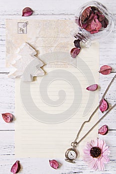 Flat lay stock photography purple flower petals letter envelope paper transparent glass bottle pocket clock Christmas tree craft