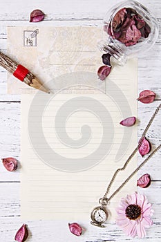 Flat lay stock photography purple flower petals letter envelope paper transparent glass bottle pocket clock wood pencil