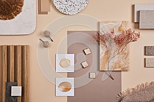 Flat lay of stylish architect mood board composition with beige samples of textile, paint, wooden lamella panels and tiles.