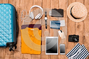 Flat lay of summer vacation things neatly organized on wooden background