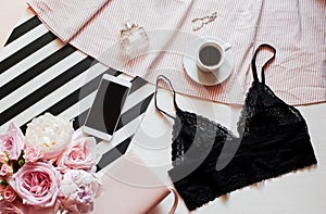 Flat lay. Top view black lace lingerie. Beauty blog concept. Bouquet of roses and pions, coffee on white background