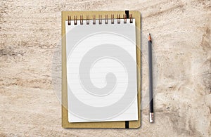 Flat lay top view with blank notepad and black pencil