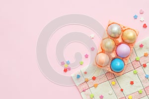 Flat lay top view colorful easter egg painted in pastel colors composition on pink pastel color background.