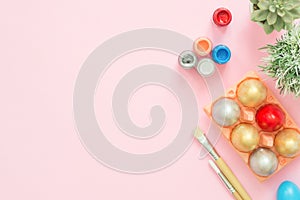 Flat lay top view colorful easter egg painted in pastel colors composition on pink pastel color background.