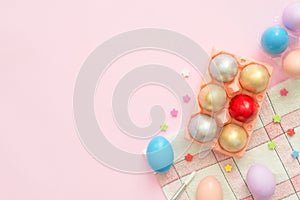 Flat lay top view colorful easter egg painted in pastel colors composition on pink pastel color background. Easter day background.