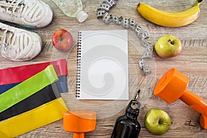 Flat lay. Top view with copy space. Healthy lifestyle, water, sports or sports equipment. Sports kit with dumbbells, tape measure