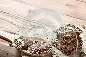 Flat lay top view crunchy flax seed crispbread with dry vegetable and linseed spoon on wooden rustic background with