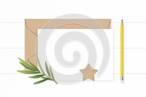 Flat lay top view elegant white composition letter paper kraft envelope star shape craft tarragon leaf and yellow pencil on wooden