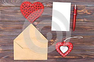 Flat lay. Top view. love letter on Saint Valentines Day. Handmade postcard with red heart shaped figure. Valentine day concept wit