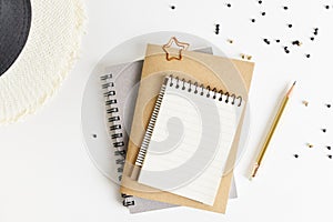 Flat lay top view notepad mockup: pencils, black beads, straw hat on white background. Clean and bright