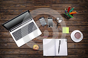 Concept freelancing, business concept, office table desk, laptop, empty notebook, cup of coffee, smartphone, calculator, wooden ba