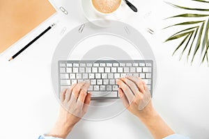 Flat lay, top view office table desk. Woman typing on keyboard.