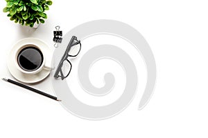 Flat lay, top view office table desk. Workspace with blank, office supplies, pencil, green leaf, and coffee cup on white