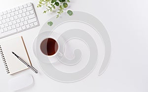 Flat lay, top view office table desk. Workspace with keyboard, office supplies, pencil and coffee cup with copy space on white