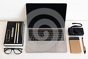 Flat lay, top view office table desk. Workspace with notebook, keyboard, office supplies and coffee cup on white background.