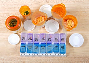 Flat lay top view of pill bottles and twice daily med box