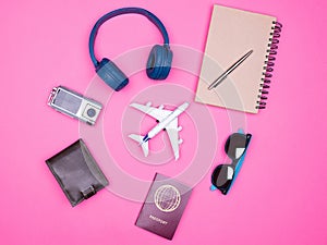 Flat lay top view of traveler photographer accessories on pink background