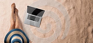 Flat lay top view of young woman with hat and laptop, summer holiday concept. Copy space.