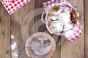 Flat lay traditional oliebollen, oil dumpling or fritter, with wooden spoon, for Dutch New Year`s Eve .Copy space