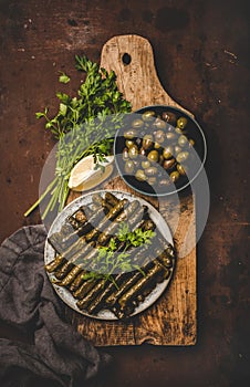 Flat-lay of traditional turkish Dolma meze or snack on board