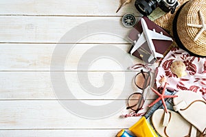 Flat lay traveler accessories on white wooden background with copy space for text. Top view travel or vacation concept