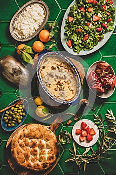 Flat-lay of Turkish dinner with lamb, pilav, salad and flatbread photo
