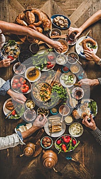 Flat-lay of Turkish family eating traditional Middle Eastern breakfast