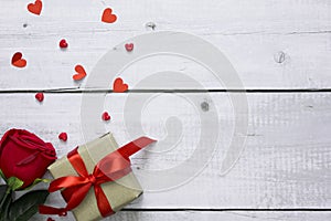 Flat lay valentine background with red rose  craft gift box and heart on white wood table with copy space for text