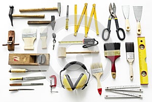 Flat lay of various technician tools on white background