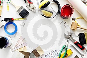 Flat lay of various technician tools on white background
