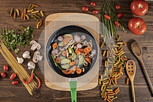 Flat lay of vegetables and food and a frying pan with food photo