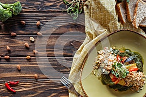 flat lay with vegetarian salad with grated almonds, pieces of bread, chili peppers and linen